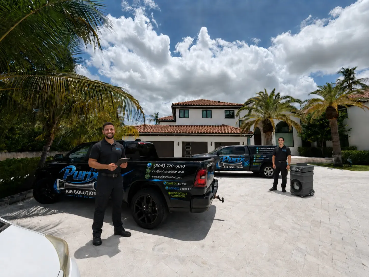 Purix technicians with service trucks at a South Florida home